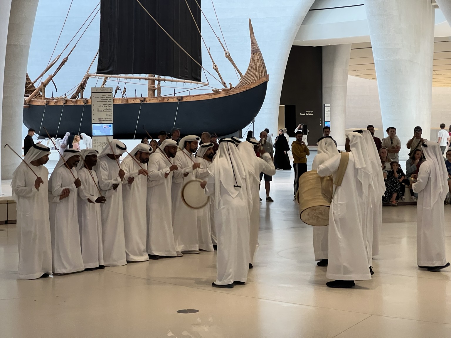 Harbiya performers at Zayed National Museum with a traditional boat