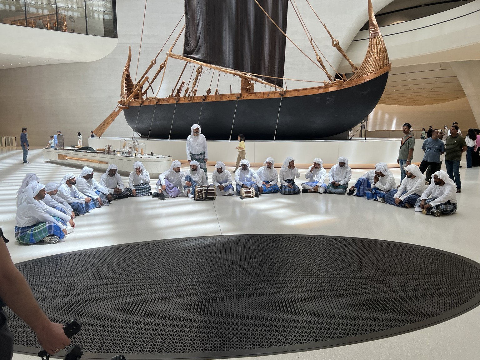 Al Nahma maritime heritage performance beside a traditional boat at Zayed National Museum