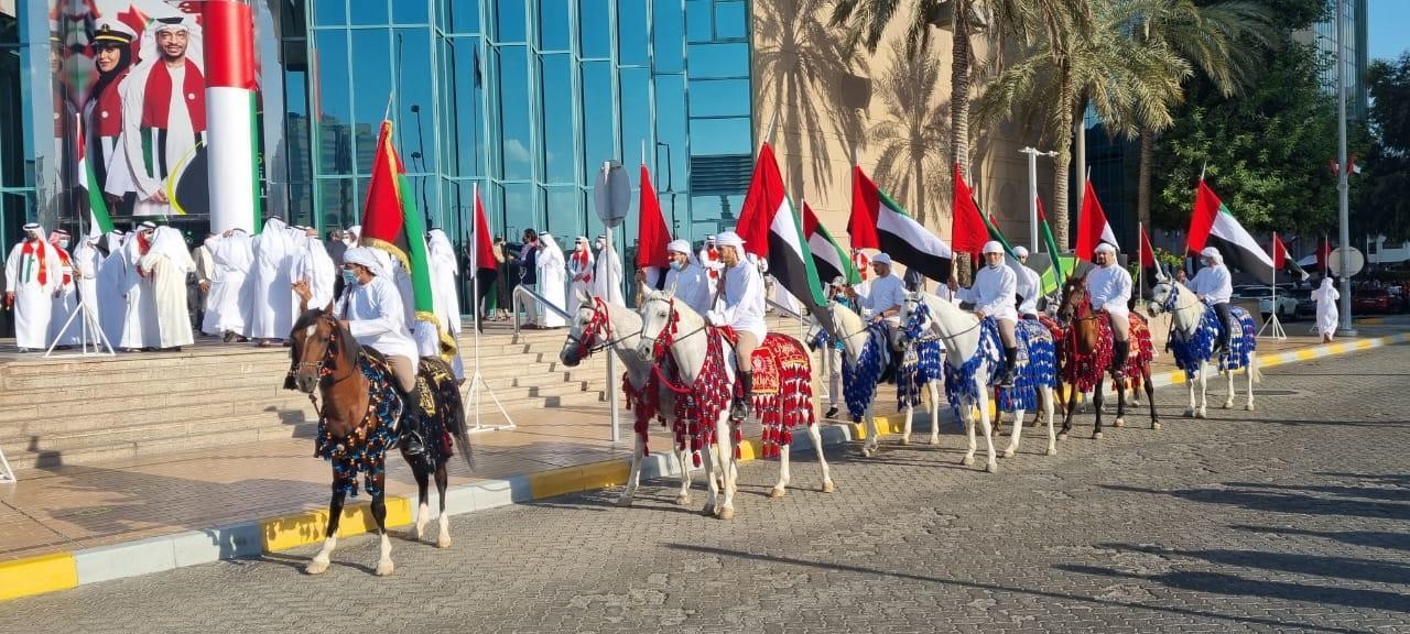 Government celebration with UAE flags and horse procession