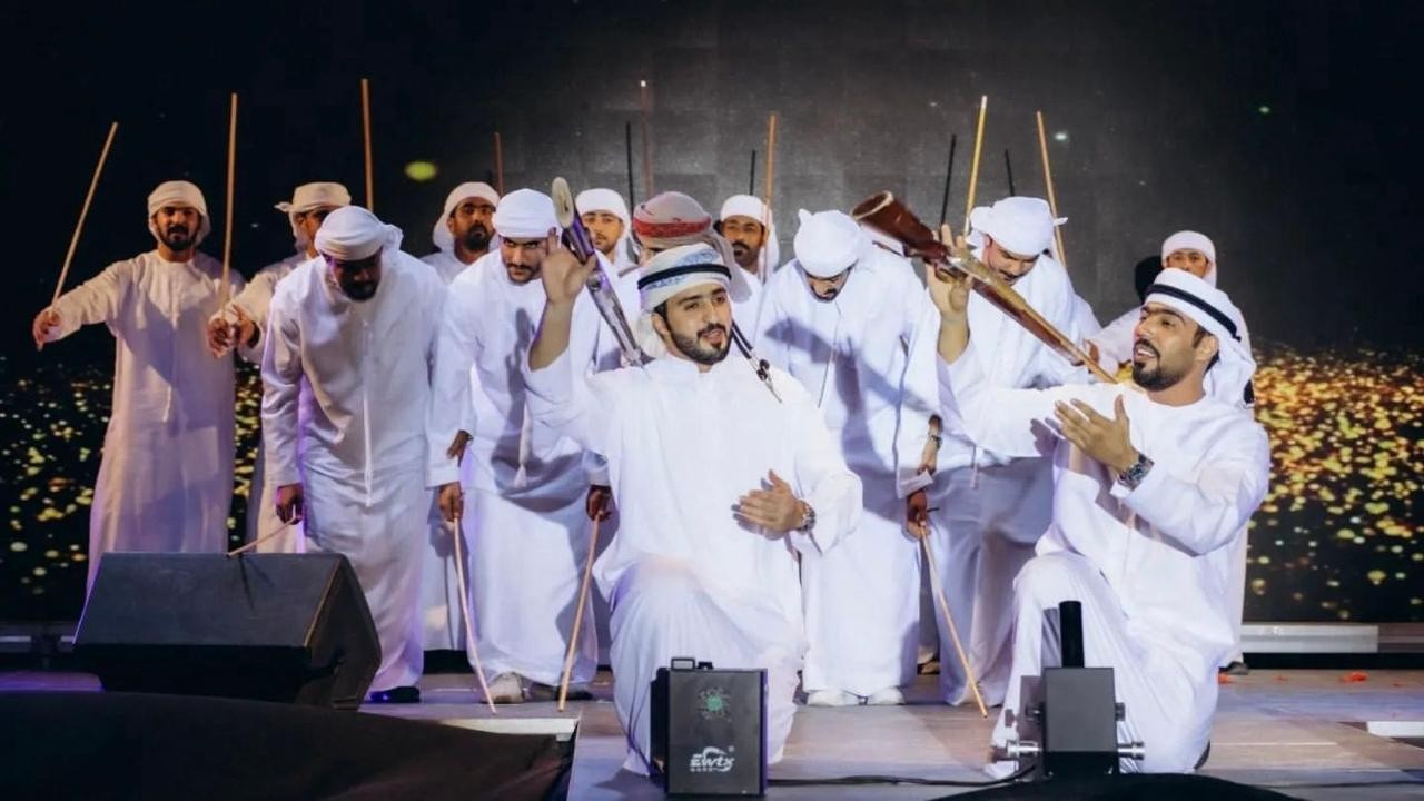Al Ayala and traditional Emirati heritage performers on stage
